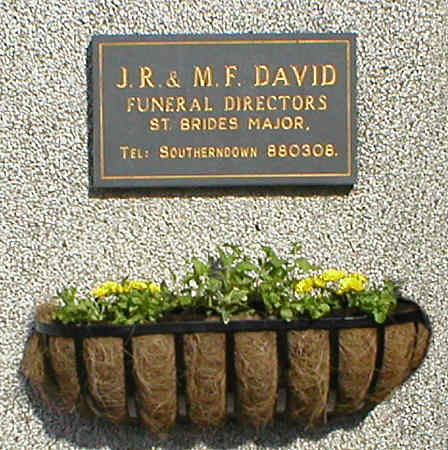 Sign J. R. & M. F. David and hanging basket